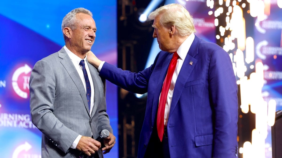 Donald Trump welcomes Robert F. Kennedy Jr. to the stage at a Turning Point Action campaign rally