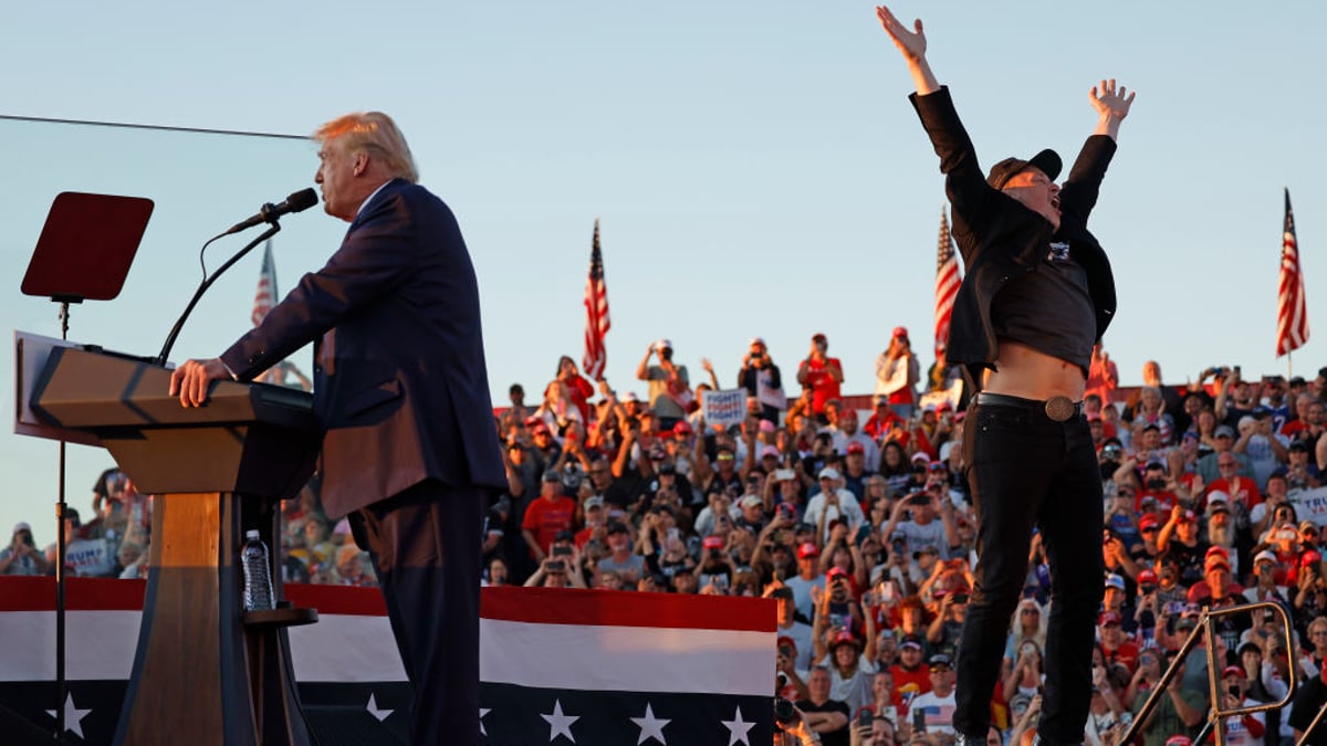 Elon Musk leaps on stage with Republican presidential nominee, former President Donald Trump during a campaign rally from behind bullet resistant glass at the Butler Farm Show fairgrounds on October 05, 2024 in Butler, Pennsylvania. This is the first time that Trump has returned to Butler since he was injured during an attempted assassination on July 13.