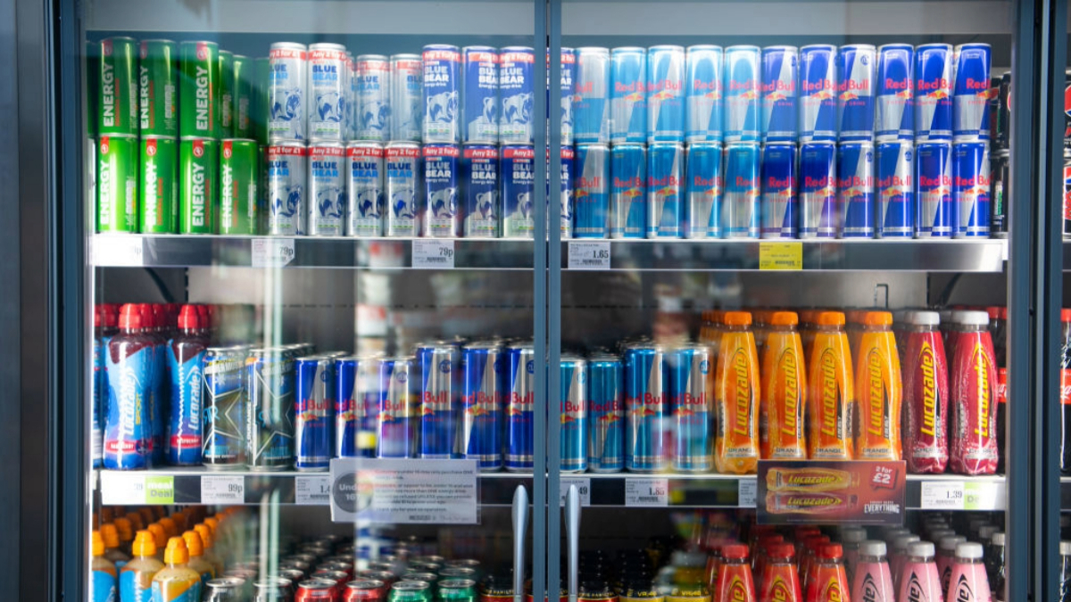 Energy drinks line the shelves in a supermarket refrigerator