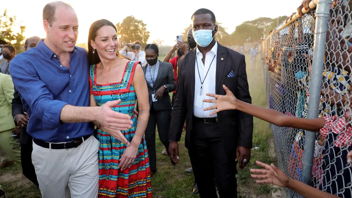 Prince William, Duke of Cambridge and Catherine, Duchess of Cambridge shake hands with children during a visit to Trench Town, the birthplace of reggae music, on day four of the Platinum Jubilee Royal Tour of the Caribbean on March 22, 2022 in Kingston, Jamaica. The Duke and Duchess of Cambridge are visiting Belize, Jamaica, and The Bahamas on their week-long tour. (Photo by Chris Jackson-Pool/Getty Images)