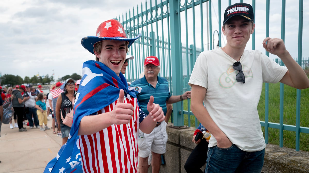 RACINE, WISCONSIN - JUNE 18: People wait for the gates to open at Festival Park where Republican presidential candidate former President Donald Trump is scheduled to hold a rally on June 18, 2024 in Racine, Wisconsin. This is Trump's third visit to Wisconsin, a key swing state, in 2024.