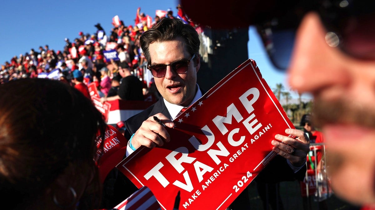 U.S. Rep. Matt Gaetz (R-FL), C, prepares to sign a Trump-Vance sign at a campaign rally for Republican presidential nominee, former U.S. President Donald Trump on October 12, 2024 in Coachella, California.