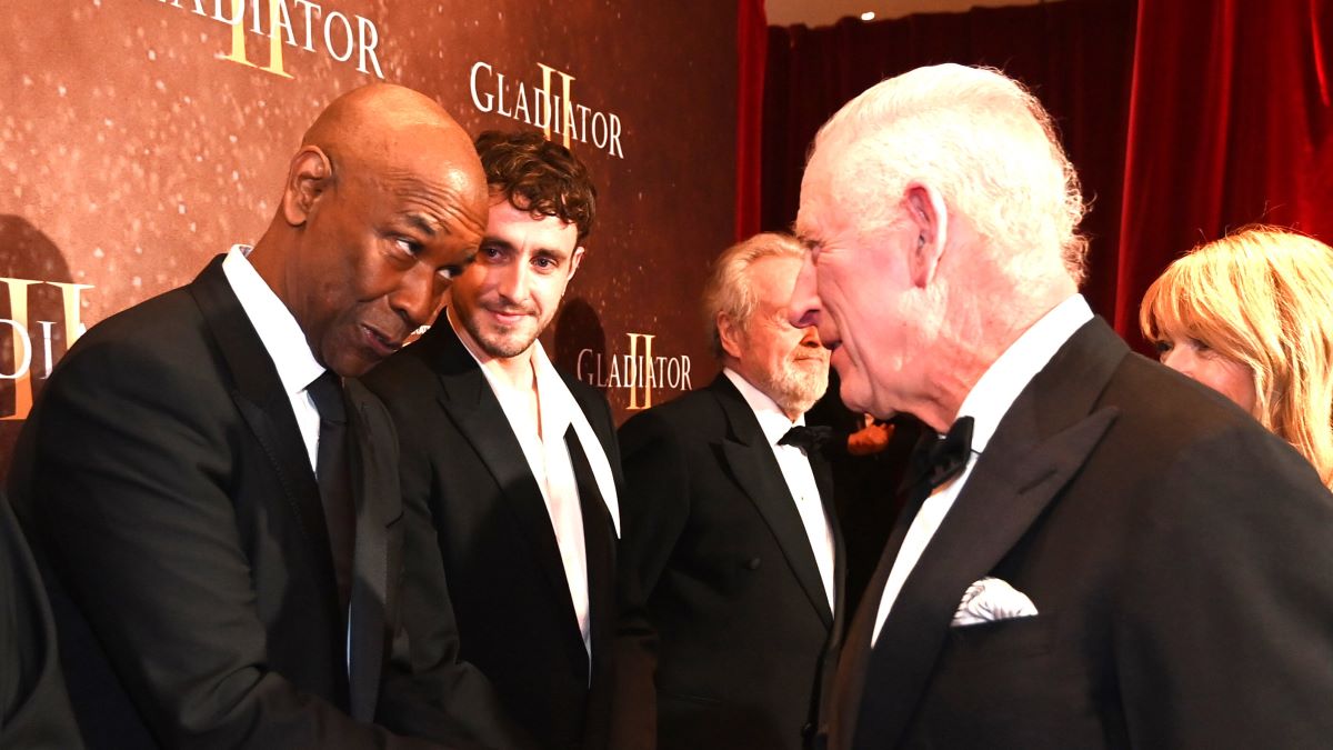 Pedro Pascal looks on as Denzel Washington meets King Charles III as they attend the Royal Film Performance and Global Premiere of "Gladiator II" in Leicester Square on November 13, 2024 in London, England. (Photo by Eddie Mulholland - WPA Pool/Getty Images)