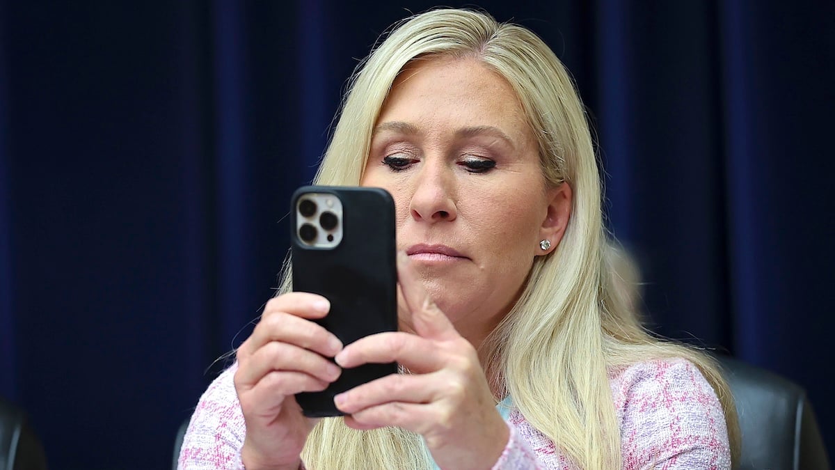 Rep. Marjorie Taylor Greene (R-GA) uses her phone while attending a hearing held by the House Select Subcommittee on the Coronavirus Pandemic