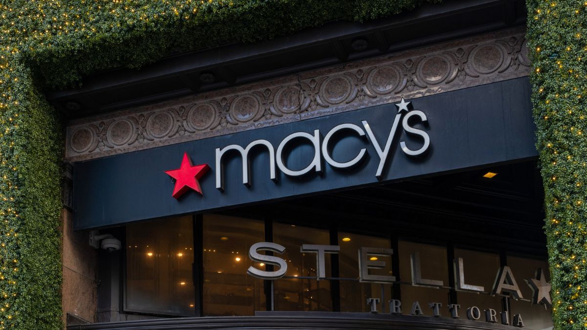 People walk by Macy's flagship Manhattan store, which is being decorated for the holiday season on November 25, 2024