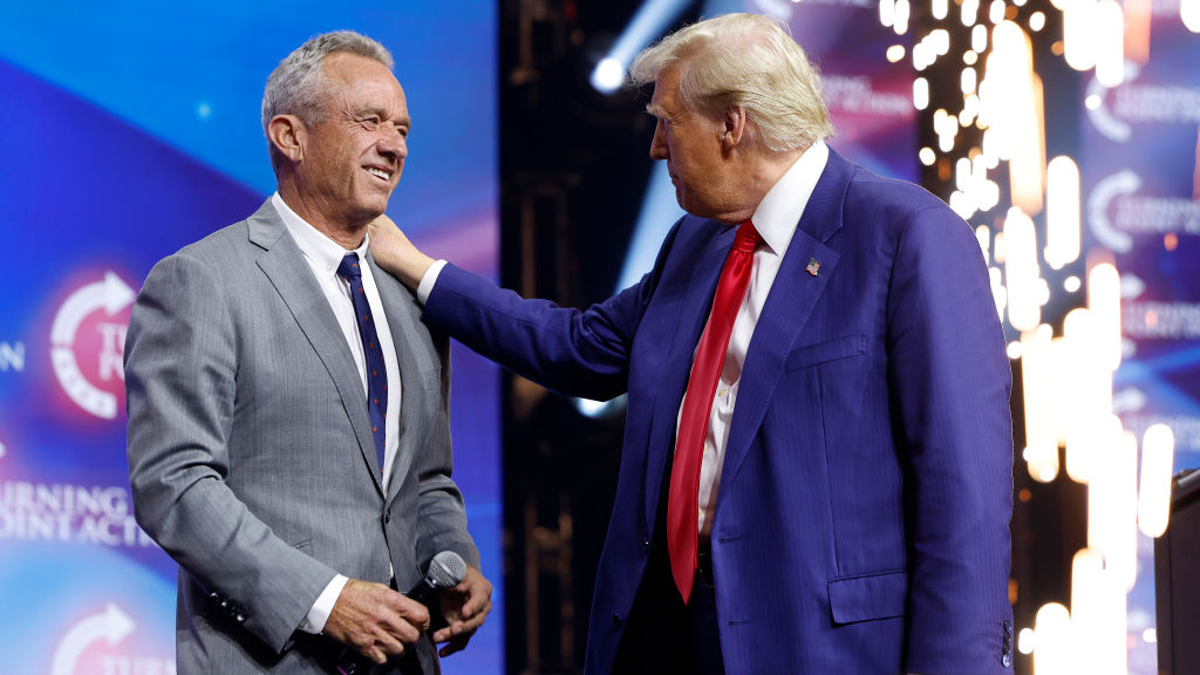 Republican presidential nominee, former U.S. President Donald Trump welcomes Robert F. Kennedy Jr. to the stage at a Turning Point Action campaign rally at the Gas South Arena on October 23, 2024 in Duluth, Georgia. Trump is campaigning across Georgia today as he and Democratic presidential nominee, U.S. Vice President Kamala Harris attempt to win over swing state voters.