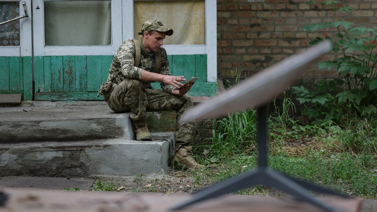 A Ukrainian soldier connects to Starlink