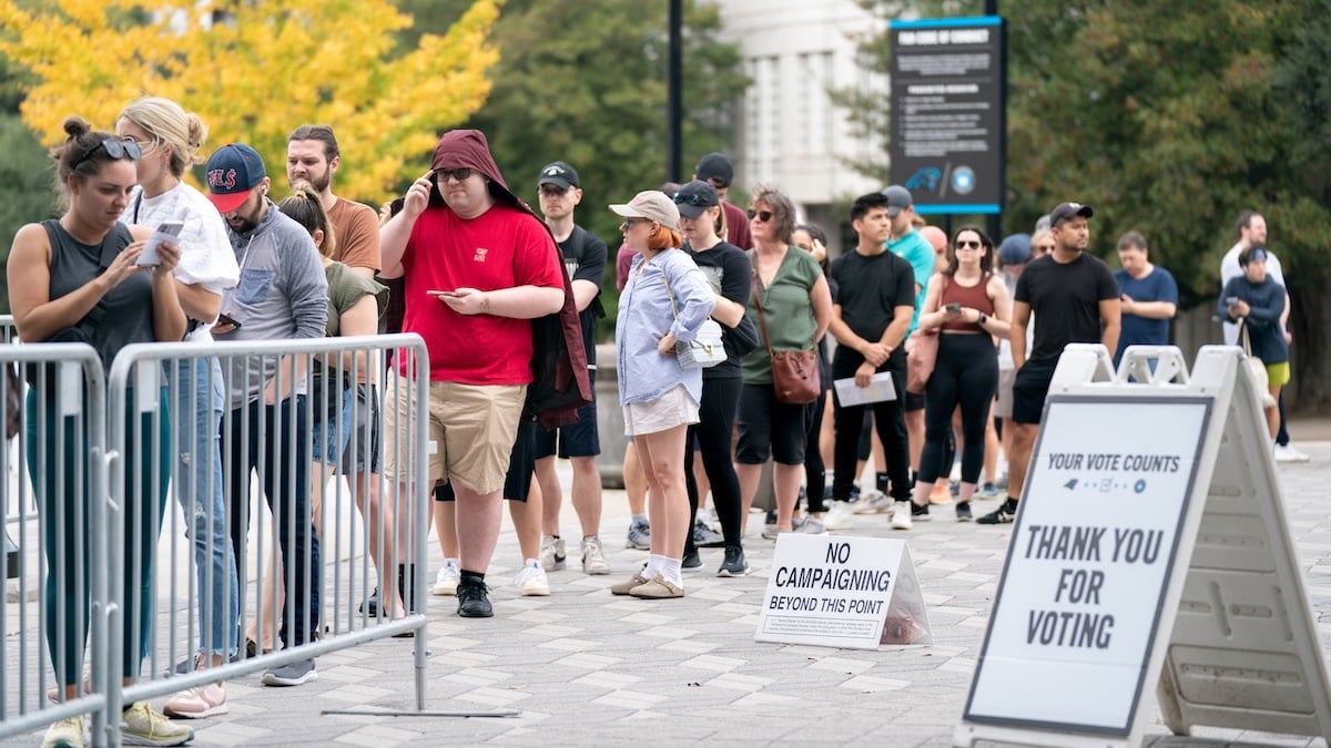 People wait in line on the final day of early voting at a polling location at Bank of America Stadium on November 5, 2022 in Charlotte, North Carolina