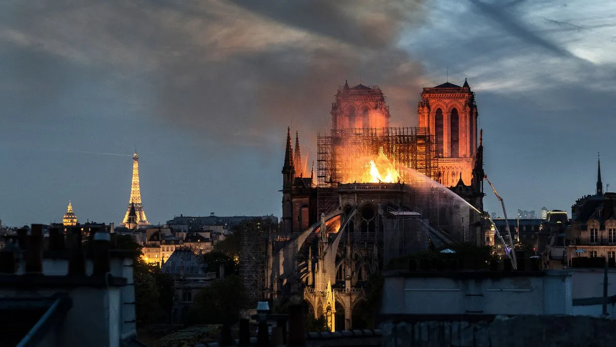 Flames and smoke are seen billowing from the roof at Notre-Dame Cathedral on April 15, 2019 in Paris, France. A fire broke out on Monday afternoon and quickly spread across the building, collapsing the spire. The cause is yet unknown but officials said it was possibly linked to ongoing renovation work. 