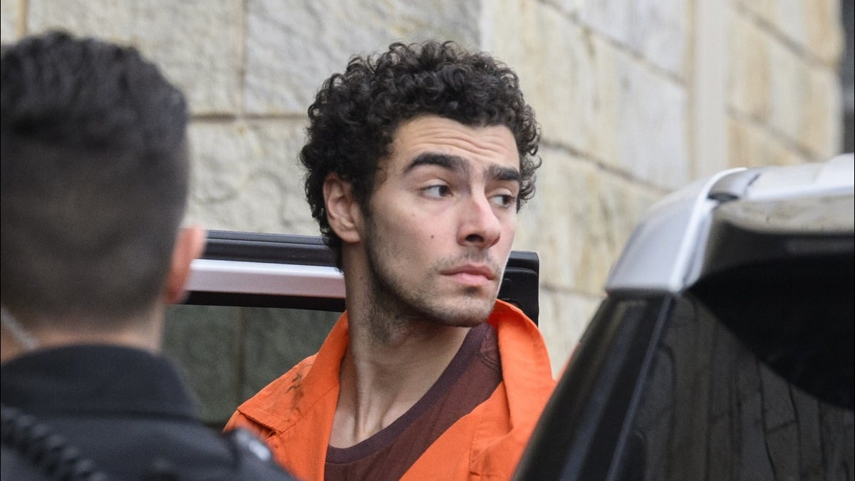 Suspected shooter Luigi Mangione is led into the Blair County Courthouse for an extradition hearing December 10, 2024 in Hollidaysburg, Pennsylvania. Mangione has been arraigned on weapons and false identification charges related to the fatal shooting of United Healthcare CEO Brian Thompson in New York City. Mangione is incarcerated in the State Correctional Institution in Huntingdon, Pennsylvania awaiting extradition to New York. (Photo by Jeff Swensen/Getty Images)