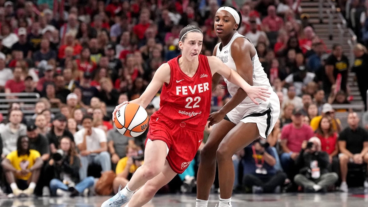 Caitlin Clark #22 of the Indiana Fever drives the ball against Jackie Young #0 of the Las Vegas Aces during the first half of a game