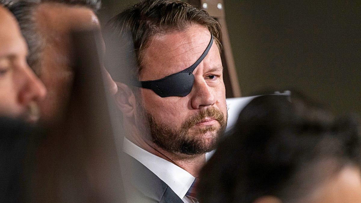 Rep. Dan Crenshaw (R-TX) listens during a press conference on Capitol Hill on June 26, 2024 in Washington, DC. Republicans in the House are attempting to hold Attorney General Derrick Garland in contempt of Congress after he advised that President Biden assert Executive Privilege over the audio and video records of his interview with Special Counsel Robert Hur.