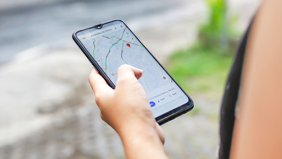 Bali,Indonesia, December 15, 2019 - Close up young woman using Google maps to check Covid - 19 community mobility reports to combat the virus spreading