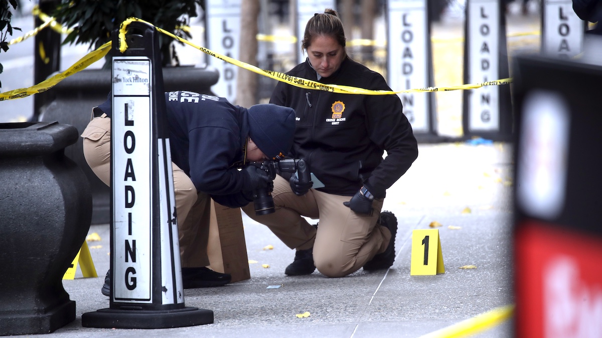 NEW YORK, NEW YORK - DECEMBER 04: Police place bullet casing markers outside of a Hilton Hotel in Midtown Manhattan where United Healthcare CEO Brian Thompson was fatally shot on December 04, 2024 in New York City. Brian Thompson was shot and killed before 7:00 AM this morning outside the Hilton Hotel, just before he was set to attend the company's annual investors' meeting.