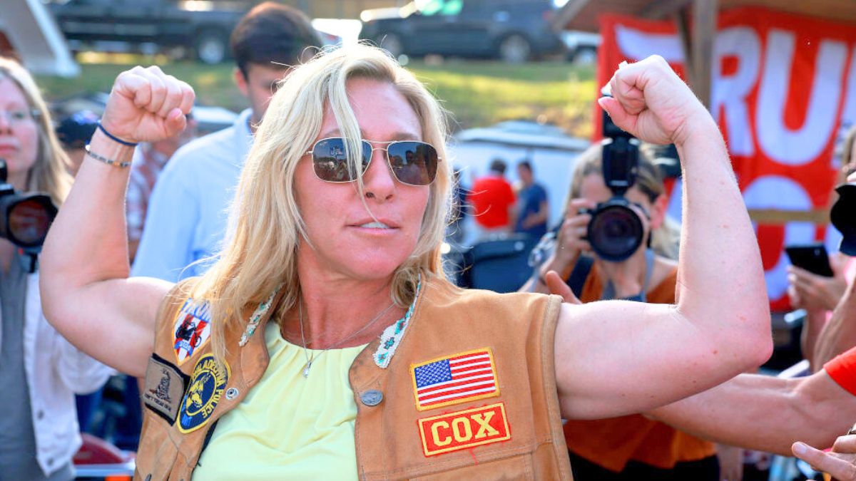 PLAINVILLE, GEORGIA - MAY 20: Rep. Marjorie Taylor Greene (R-GA) flexes her muscles during a Bikers for Trump campaign event held at the Crazy Acres Bar & Grill on May 20, 2022 in Plainville, Georgia. Rep. Greene is running for a second congressional term in the state's upcoming midterm primary. (Photo by Joe Raedle/Getty Images)