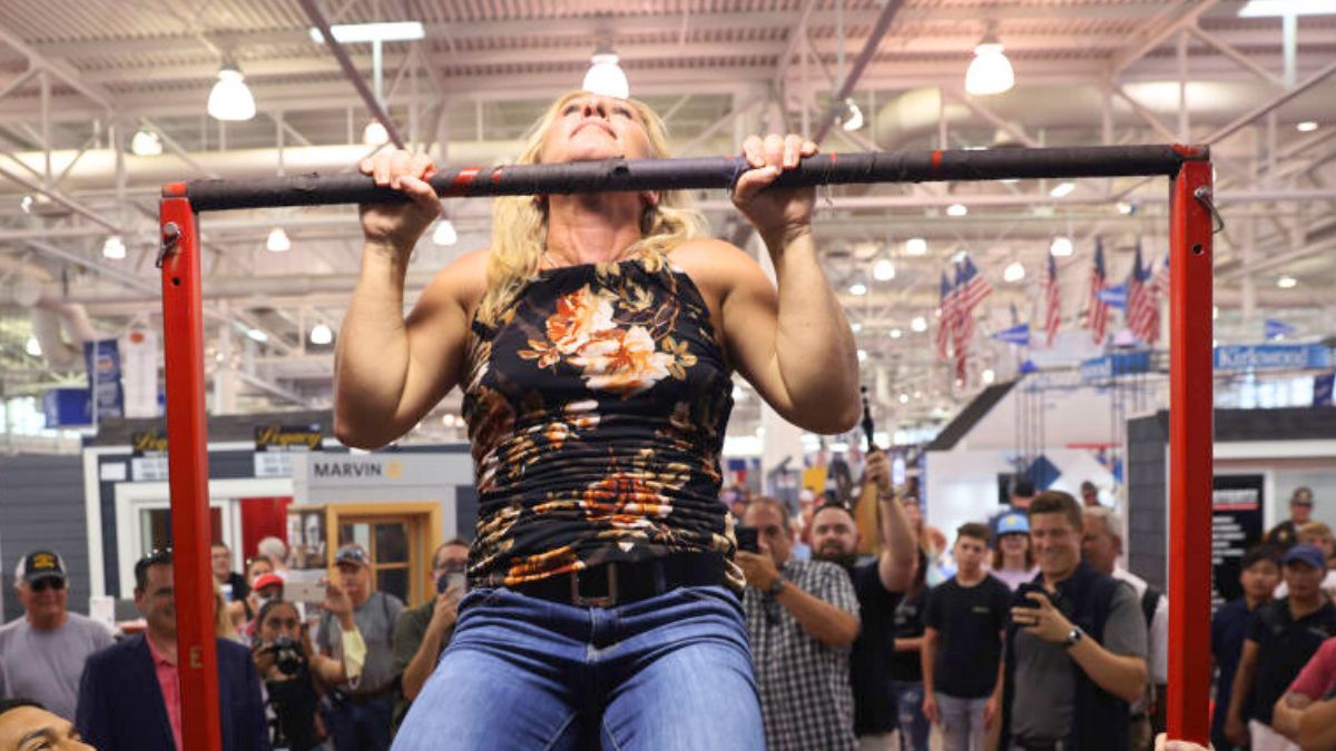 DES MOINES, IOWA - AUGUST 19: U.S. Rep. Marjorie Taylor Greene (R-GA) takes the pull-up challenge at the Marine Corps recruiting booth during a visit to the Iowa State Fair on August 19, 2021 in Des Moines, Iowa. Greene completed 8 pull-ups during the challenge. The fair is often used by politicians seeking to test the waters before jumping into a presidential race. Greene said, during her visit, that she supports former President Donald Trump for the 2024 Republican nomination. (Photo by Scott Olson/Getty Images)