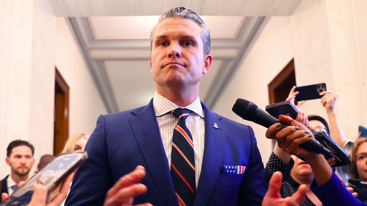 Pete Hegseth pauses to talk to reporters after a series of meetings with senators in the Russell Senate Office Building