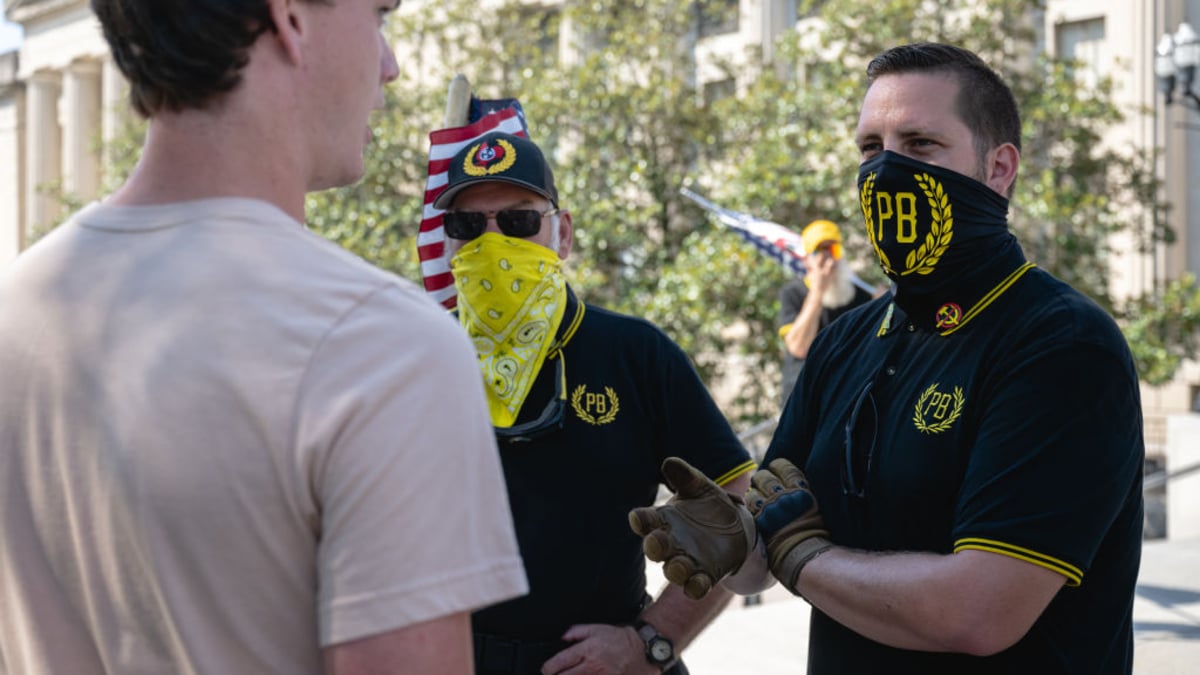 A person engages members of the Proud Boys in dialogue ahead of the special session on August 21, 2023 in Nashville, Tennessee. Republican Tennessee Governor Bill Lee called for the special legislation session on public safety in response to public outcry after the The Covenant School mass shooting, where three children and three staff were killed.