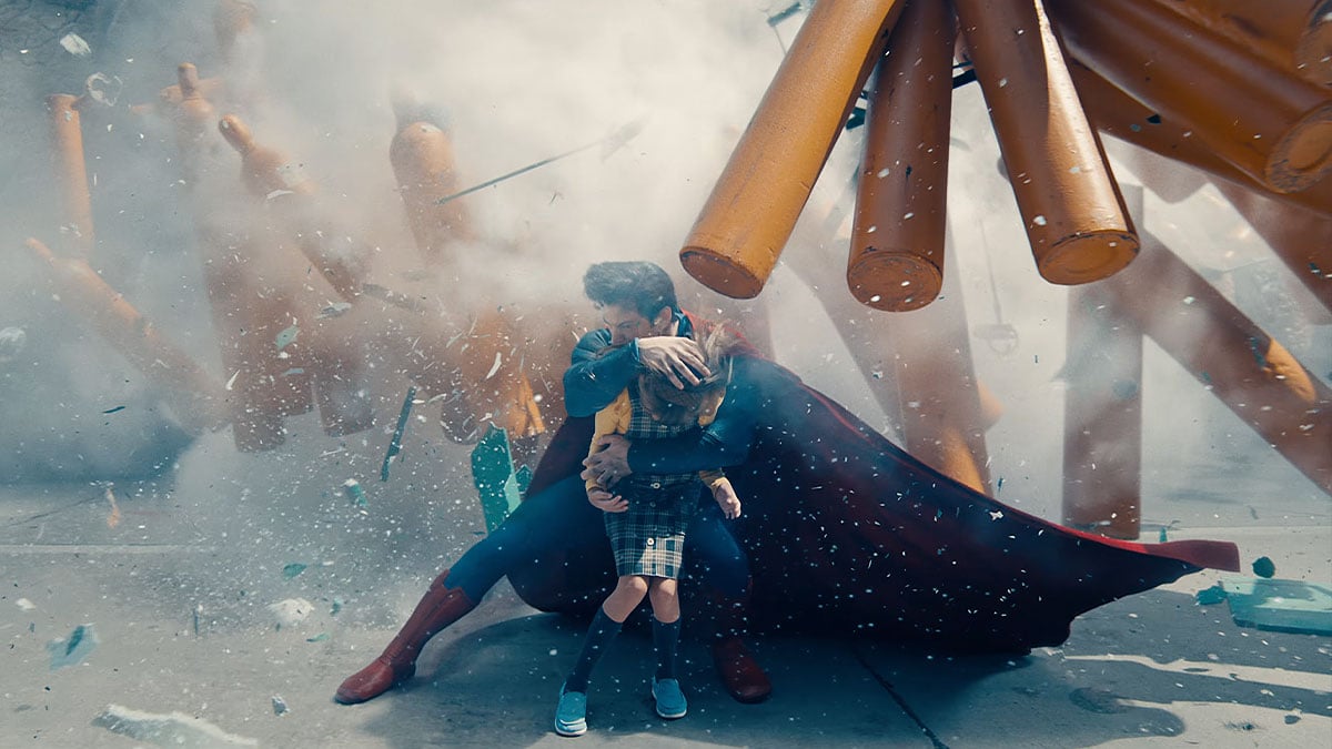 Superman protecting a young girl from an explosion