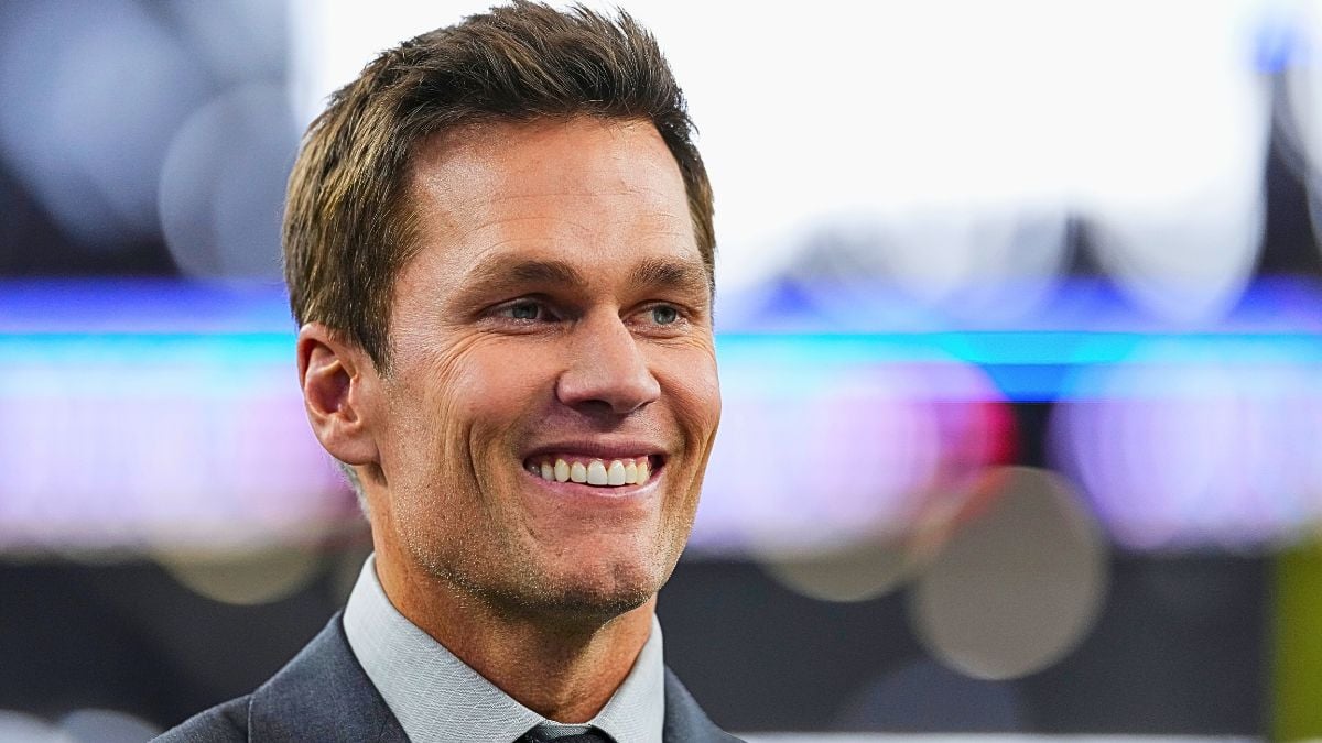 Tom Brady looks on from the field prior to an NFL football game between the New York Giants and the Dallas Cowboys at AT&T Stadium on November 28, 2024 in Arlington, Texas.