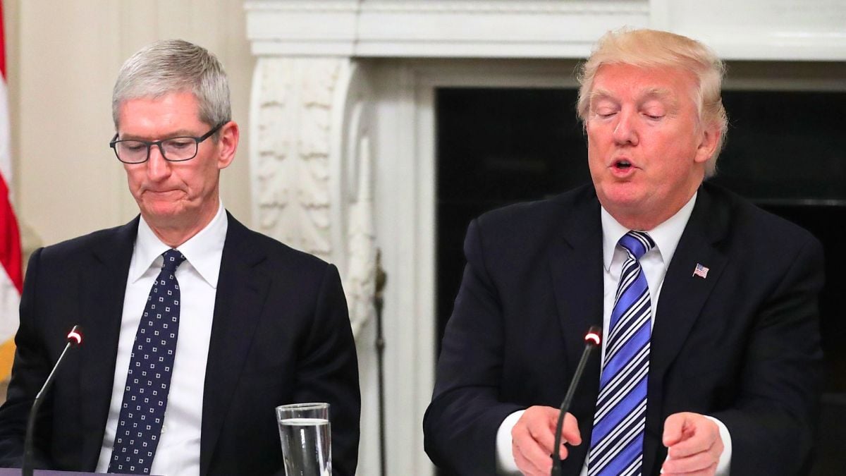 Apple CEO Tim Cook listens to U.S. President Donald Trump deliver opening remarks during a meeting of the American Technology Council