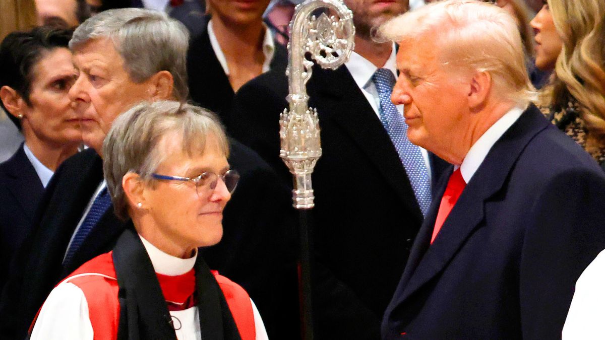 Bishop Mariann Edgar Budde (L) arrives as U.S. President Donald Trump looks on during the National Prayer Service at Washington National Cathedral