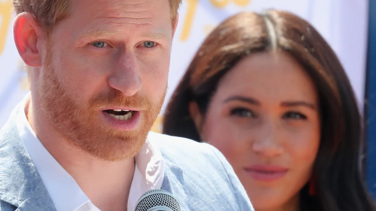 JOHANNESBURG, SOUTH AFRICA - OCTOBER 02: Meghan, Duchess of Sussex looks on as Prince Harry, Duke of Sussex speaks during a visit a township to learn about Youth Employment Services on October 02, 2019 in Johannesburg, South Africa..