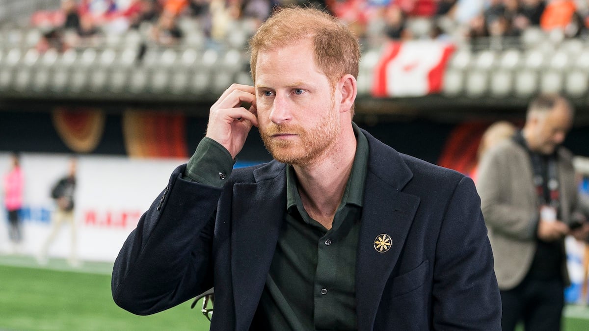 VANCOUVER, CANADA - NOVEMBER 17: Prince Harry adjusts his ear piece prior to the start of a TV interview during pre-game festivities before the start of the 2024 Grey Cup at BC Place on November 17, 2024 in Vancouver, Canada.