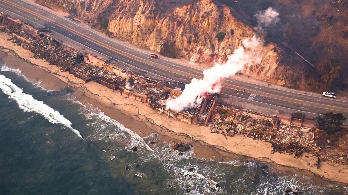 An aerial view of destroyed homes along the beach as the Palisades Fire continues to burn on January 09, 2025 in Malibu, California. Multiple wildfires fueled by intense Santa Ana Winds are burning across Los Angeles County. At least five people have been killed, and over 25,000 acres have burned. Over 2,000 structures have also burned and almost 180,000 people are under orders to evacuate.