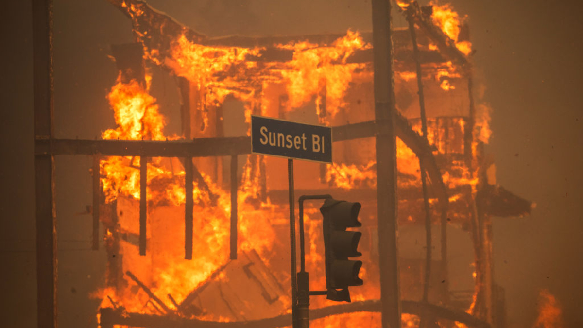 Flames from the Palisades Fire burn a building on Sunset Boulevard amid a powerful windstorm on January 8, 2025 in the Pacific Palisades neighborhood of Los Angeles, California. Fueled by intense Santa Ana Winds, the Palisades Fire has grown to over 15,000 acres and 30,000 people have been ordered to evacuate while a second major fire continues to burn near Eaton Canyon in Altadena.