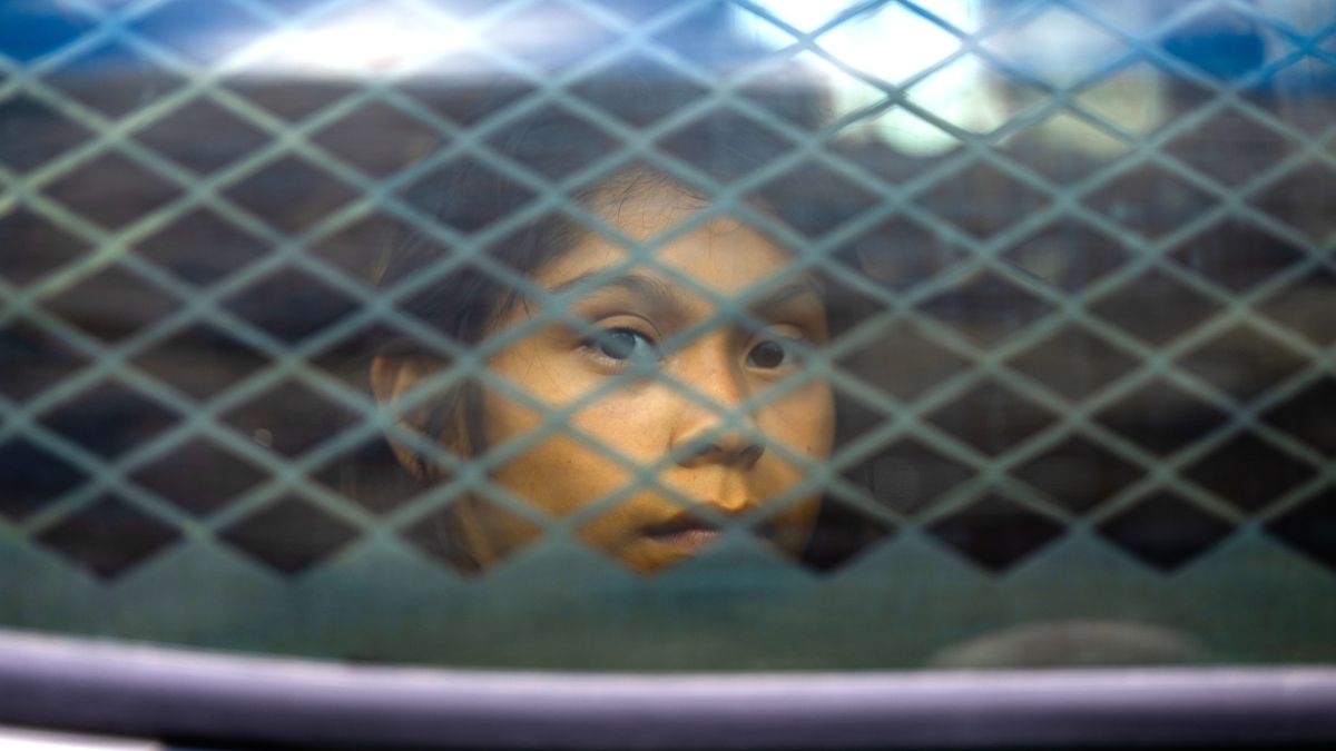 A migrant child sits in the back of a border patrol vehicle after being apprehended by U.S. Customs and Border protection officers on June 24, 2024 in Ruby, Arizona. President Joe Biden has announced an immigration relief plan, which promises a path to citizenship for approximately 500,000 undocumented immigrants married to or adopted by U.S. citizens. Day's after Biden's announcement, Republican presidential candidate, former U.S. President Donald Trump announced to a podcast host that he would solidify green cards for foreign nationals who've received a U.S. college diploma. (Photo by Brandon Bell/Getty Images)