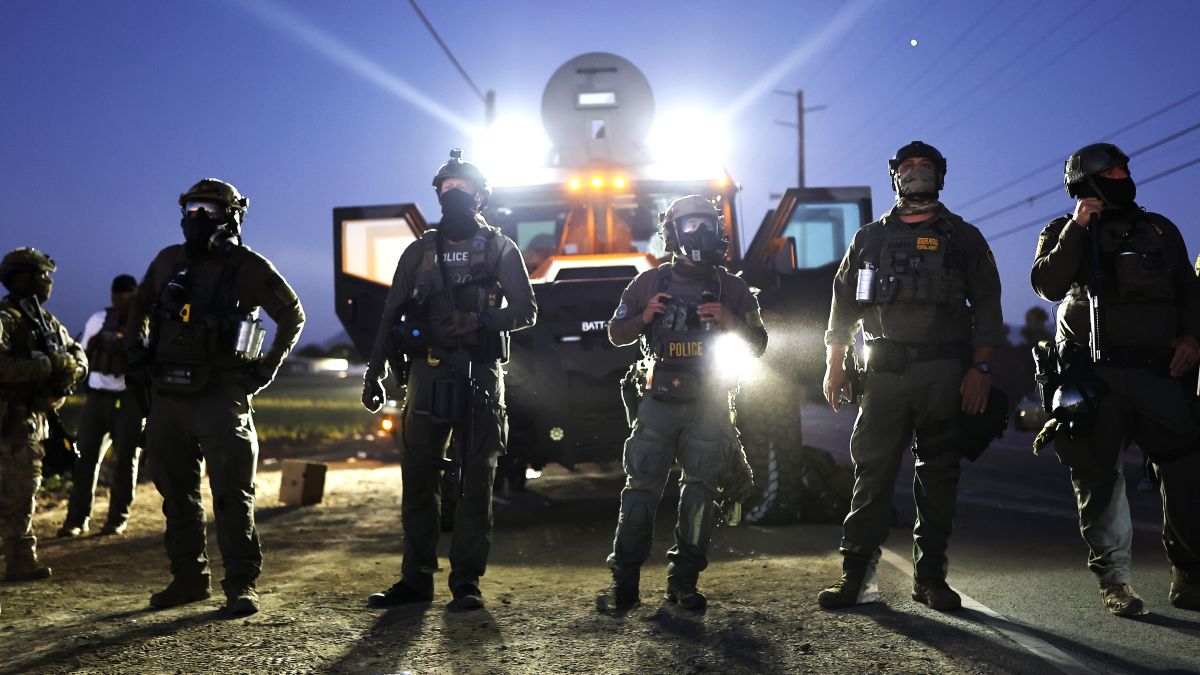 Federal agents block people protesting an ICE immigration raid at a nearby licensed cannabis farm on July 10, 2025 near Camarillo, California. Protestors stood off with federal agents for hours outside the farm in the farmworker community in Ventura County. A Los Angeles federal judge is set to rule Friday on a temporary restraining order which would restrict area immigration enforcement operations. (Photo by Mario Tama/Getty Images)