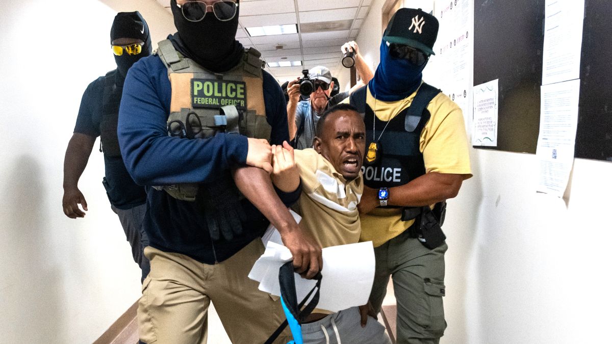 Federal agents, including members of ICE, drag a man away after his court hearing as they patrol the halls of immigration court at the Jacob K. Javitz Federal Building on July 24, 2025 in New York City. In a news conference on Monday, Border czar Tom Homan said he is going to "flood" sanctuary cities, including New York City, with ICE agents. (Photo by Spencer Platt/Getty Images)