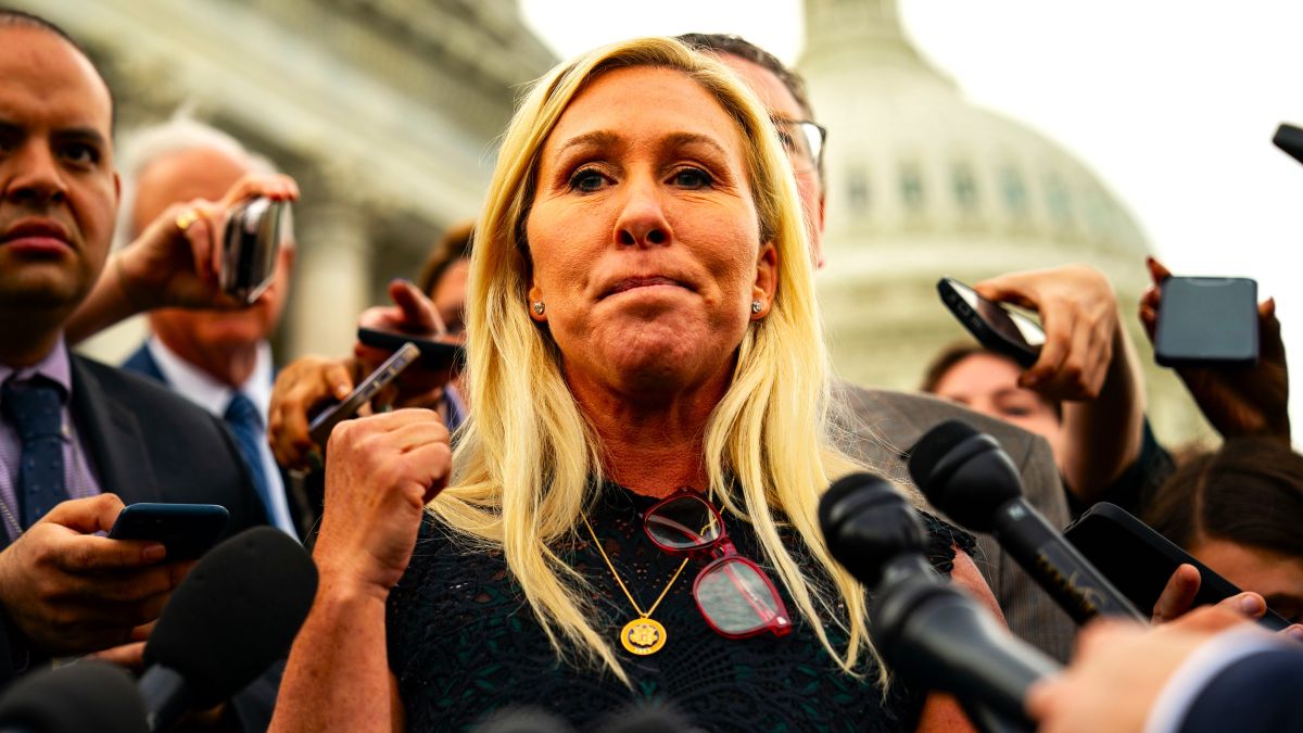 Rep. Marjorie Taylor Greene (R-GA), and Rep. Thomas Massie (R-KY) (behind), speak to members of the press on the steps of the House of Representatives at the U.S. Capitol on May 8, 2024 in Washington, DC. The House voted overwhelmingly to save Speaker Johnson from Marjorie Taylor Greene's push to oust him from his leadership position, voting 359 to 43 to table the motion to vacate. (Photo by Kent Nishimura/Getty Images)