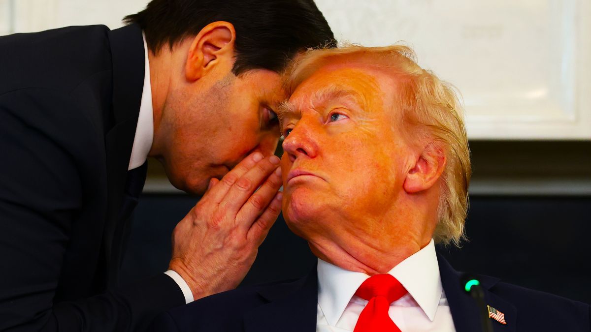U.S. Secretary of State Marco Rubio (L) speaks to U.S. President Donald Trump during a roundtable discussion in the State Dining Room of the White House on October 08, 2025 in Washington, DC. Trump’s administration held the roundtable to discuss the anti-fascist Antifa movement after signing an executive order designating it as a “domestic terrorist organization”. (Photo by Anna Moneymaker/Getty Images)