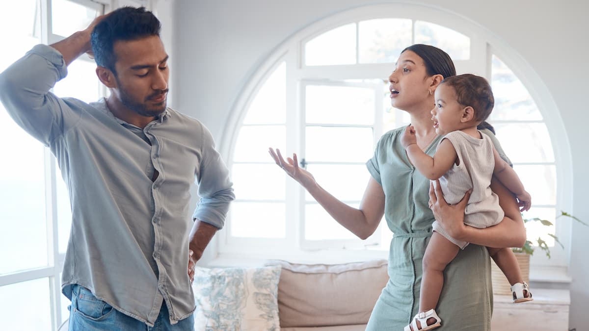 Shot of a young couple looking frustrated and arguing in the lounge at home - stock photo