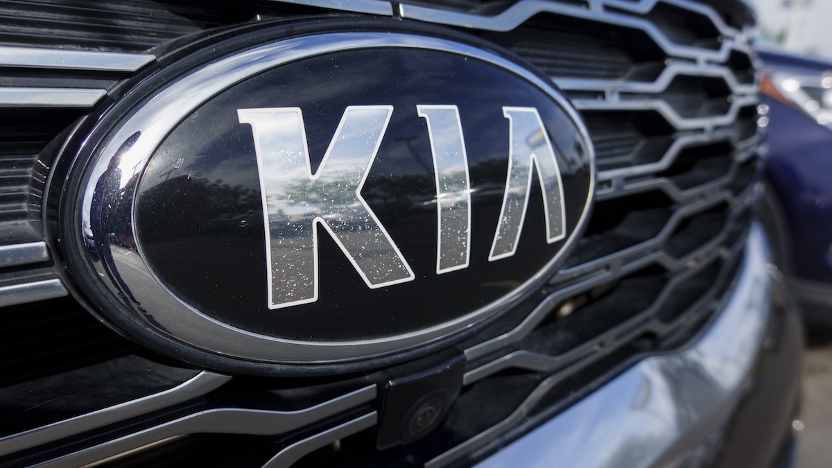 SAN DIEGO, CALIFORNIA - NOVEMBER 11: A Kia logo is displayed on a used vehicle for sale at a dealership on November 11, 2025 in San Diego, CA.