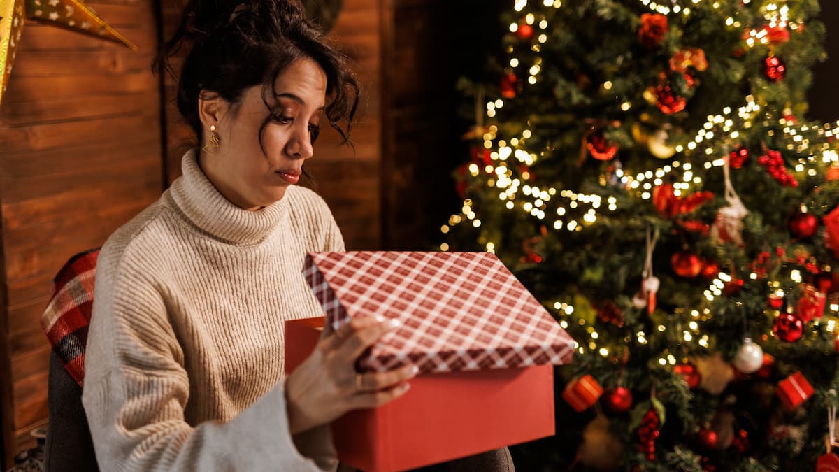 Woman opening Christmas gift