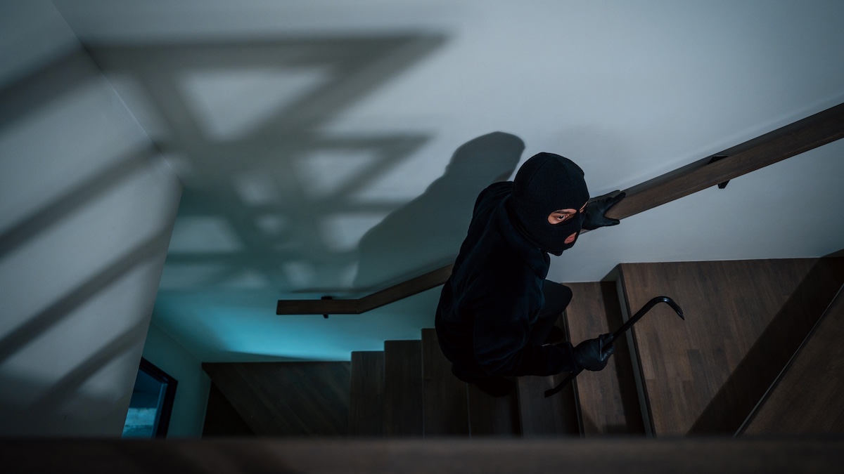 Thief in uniform black jacket various action housebreak. The Robber terrorism criminal escapes with balaclava and crowbar entering a house for stealing Housebreak at night