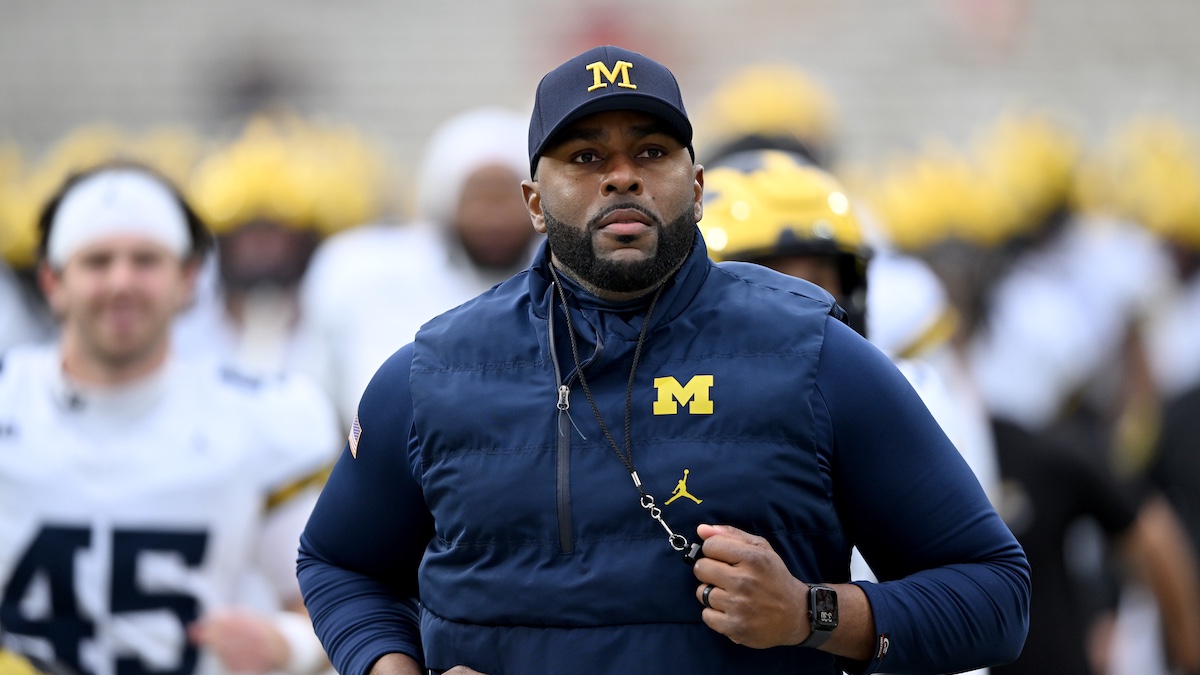 COLLEGE PARK, MARYLAND - NOVEMBER 22: Head coach Sherrone Moore of the Michigan Wolverines leads his team off the field after warm-ups before the game against the Maryland Terrapins at SECU Stadium on November 22, 2025 in College Park, Maryland.
