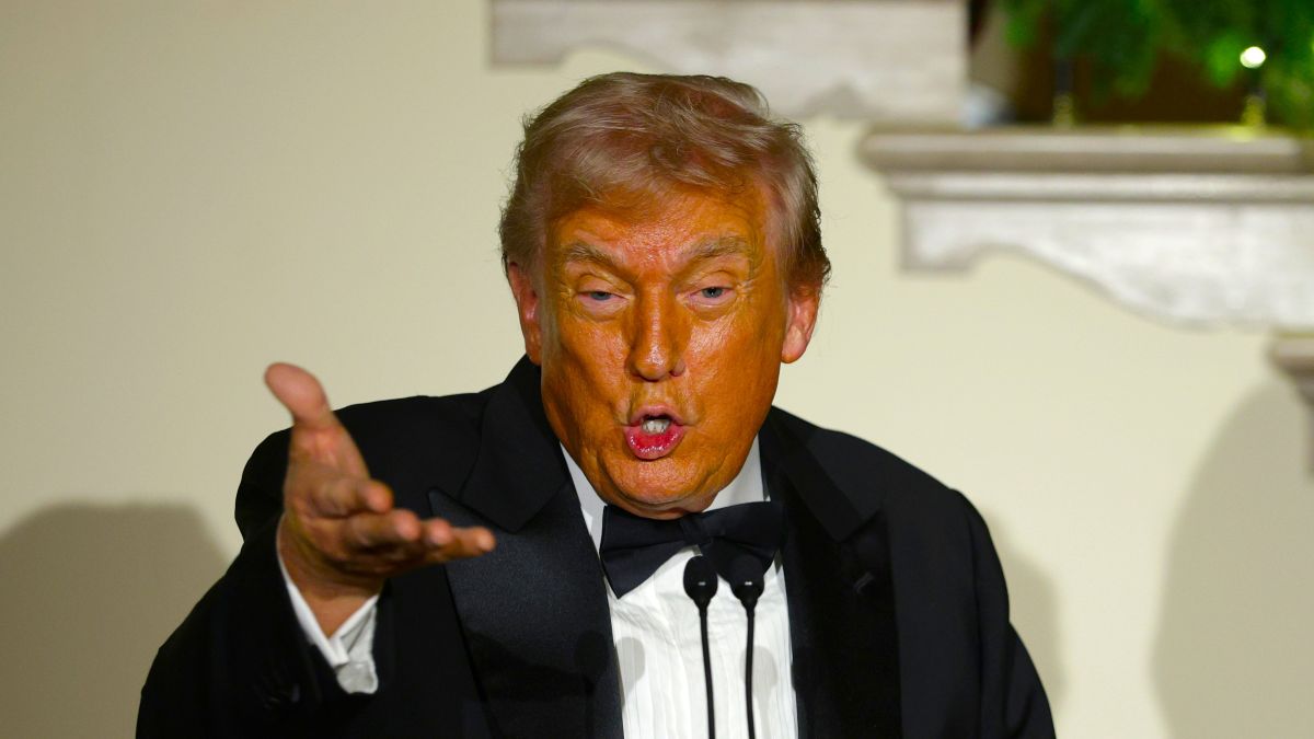 U.S. President Donald Trump (L) delivers remarks as First Lady Melania Trump (R) looks during the Congressional Ball at the Grand Foyer of the White House on December 11, 2025 in Washington, DC. President Trump hosted congressional members at the White House to celebrate the holiday season. (Photo by Alex Wong/Getty Images)