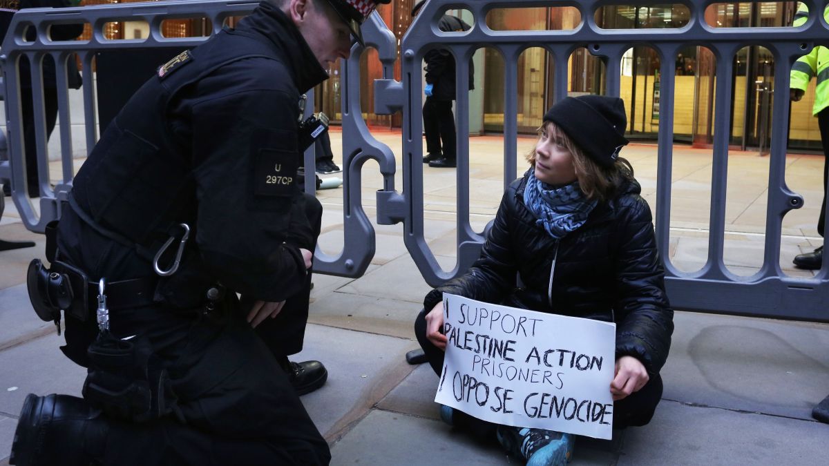 Activist Greta Thunberg joins the protest outside the offices of Aspen Insurance and holds a sign saying 'I support Palestine Action Prisoners I oppose Genocide' on December 23, 2025 in London, England. The activists targeted the company due to its alleged business relationship with the Israeli defence contractor Elbit Systems. They are also protesting in support of six of the so-called "Filton 24" prisoners who were arrested in 2024 and have been refusing food for over 50 days while being held on remand ahead of a trial. (Photo by Martin Pope/Getty Images)