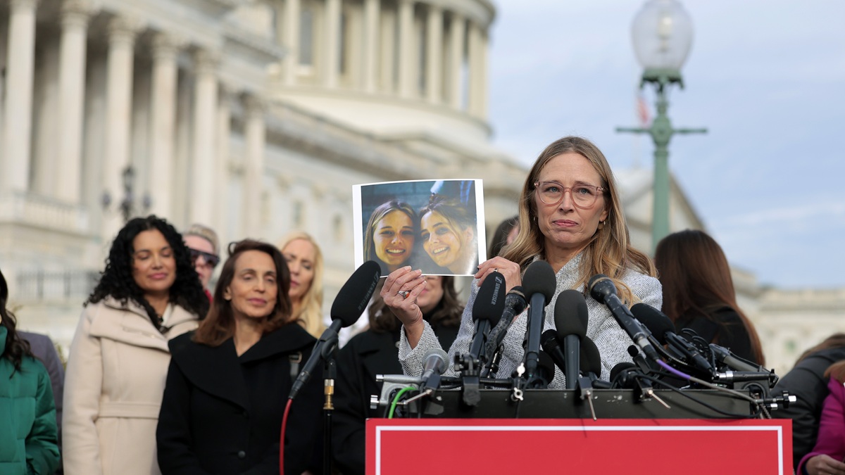 WASHINGTON, DC - NOVEMBER 18: Epstein abuse survivor Annie Farmer holds up a photo of her younger self with her sister Maria Farmer during a news conference with lawmakers on the Epstein Files Transparency Act outside the U.S. Capitol on November 18, 2025 in Washington, DC. The House is expected to vote today on the legislation, which instructs the U.S. Department of Justice to release all files related to the late accused sex trafficker Jeffrey Epstein. (Photo by Heather Diehl/Getty Images)
