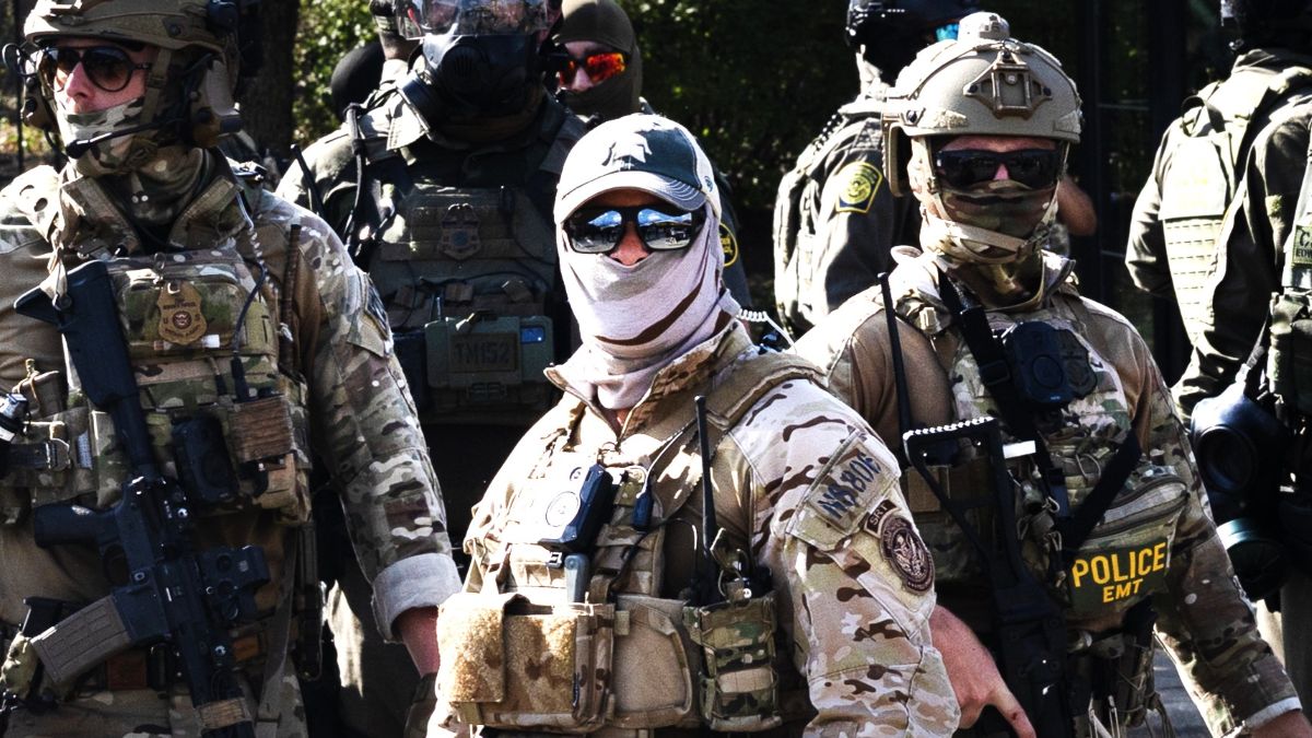 Federal law enforcement agents are confronted by community members and activists after reportedly shooting a woman in the Brighton Park neighborhood on October 04, 2025 in Broadview, Illinois. Residents of the city have become increasingly concerned as Operation Midway Blitz continues in the Chicago area, an operation designed to apprehend and deport undocumented immigrants living in the area. (Photo by Scott Olson/Getty Images)