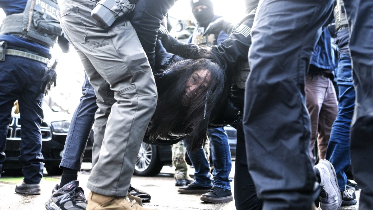 ICE agents detain a woman after pulling her from a car on January 13, 2026 in Minneapolis, Minnesota. The Trump administration has deployed over 2,400 Department of Homeland Security agents to the state of Minnesota in a push to apprehend undocumented immigrants. (Photo by Stephen Maturen/Getty Images)