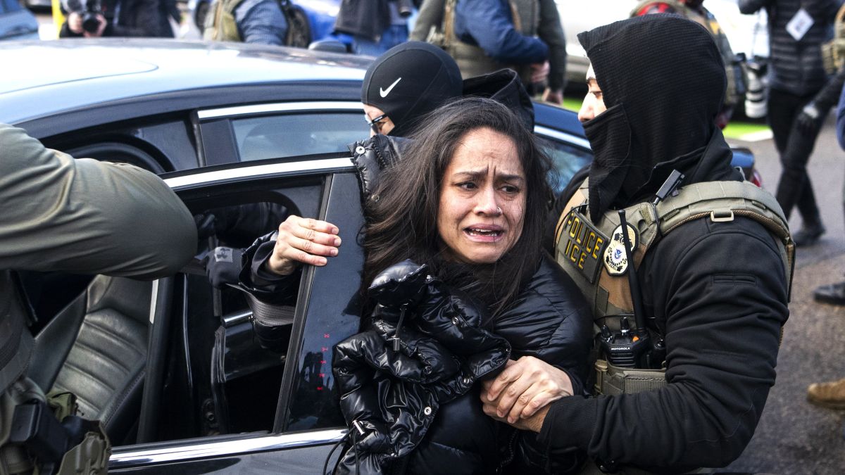 ICE agents detain a woman after pulling her from a car on January 13, 2026 in Minneapolis, Minnesota. The Trump administration has deployed over 2,400 Department of Homeland Security agents to the state of Minnesota in a push to apprehend undocumented immigrants. (Photo by Stephen Maturen/Getty Images)