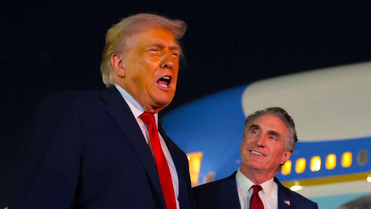 U.S. President Donald Trump (L) talks with reporters as U.S. Secretary of the Interior Doug Burgum (R) looks on at Palm Beach International Airport on January 19, 2026 in West Palm Beach, Florida. President Trump attended this year’s college football national championship game at Hard Rock Stadium between the Indiana Hoosiers and the Miami Hurricanes. (Photo by Anna Moneymaker/Getty Images)