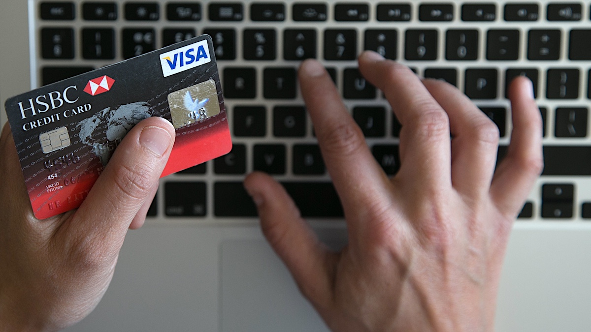 BRISTOL, UNITED KINGDOM - AUGUST 11: In this photo illustration a woman uses a credit card to buy something online on August 11, 2014 in Bristol, United Kingdom. This week marks the 20th anniversary of the first online sale. Since that sale - a copy of an album by the artist Sting - online retailing has grown to such an extent that it is now claimed that 95 percent of the UK population has shopped online and close to one in four deciding to shop online each week.
