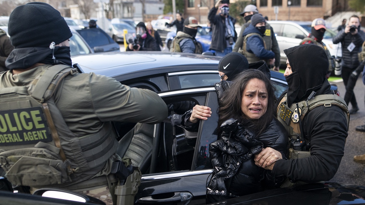 MINNEAPOLIS, MINNESOTA - JANUARY 13: ICE agents detain a woman after pulling her from a car on January 13, 2026 in Minneapolis, Minnesota. The Trump administration has deployed over 2,400 Department of Homeland Security agents to the state of Minnesota in a push to apprehend undocumented immigrants. (Photo by Stephen Maturen/Getty Images)