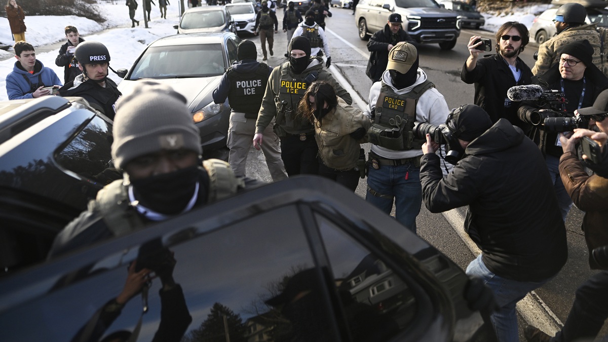 MINNEAPOLIS, MINNESOTA - JANUARY 13: An observer is detained by ICE agents after they arrested two people from a residence on January 13, 2026 in Minneapolis, Minnesota. The Trump administration has deployed over 2,400 Department of Homeland Security agents to the state of Minnesota in a push to apprehend undocumented immigrants. (Photo by Stephen Maturen/Getty Images)